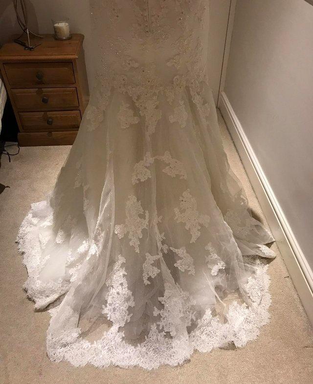 Preview of the first image of Beautiful Ivory Wedding Dress never been worn! S12 unaltered.