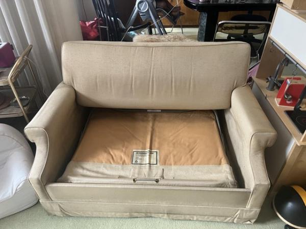 Image 3 of A two seater sofa bed upholstered