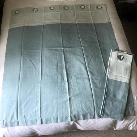 Image 1 of Unused eyelet light blue curtains. Each 56" long x 46" wide