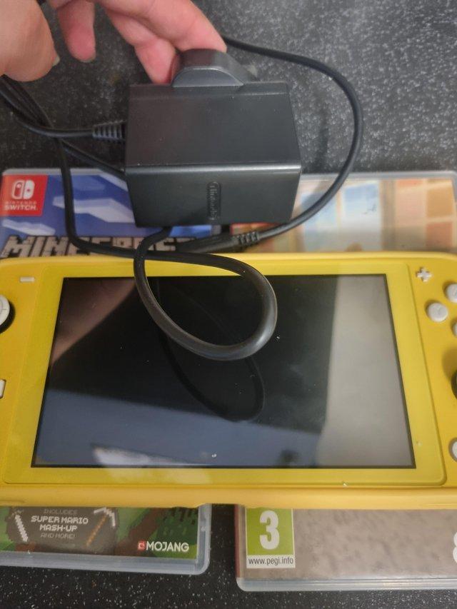 Preview of the first image of Yellow nintendo switch lite and games.