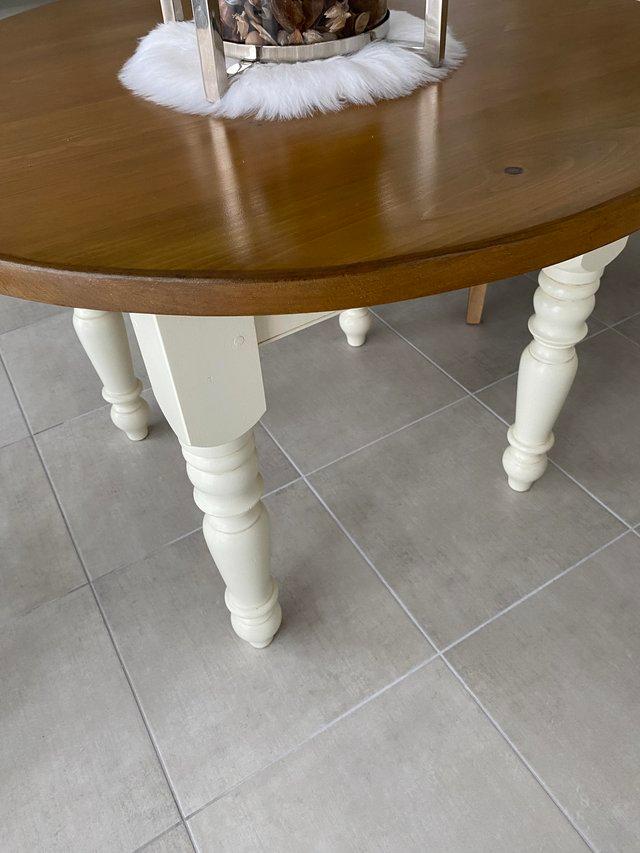 Preview of the first image of Wood and cream base legged table.